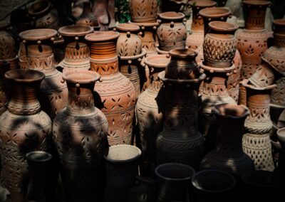 Collection of intricately designed terracotta vases displayed outdoors in natural light.